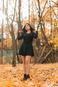 Young woman standing in forest