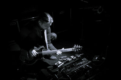 Man playing guitar at music concert