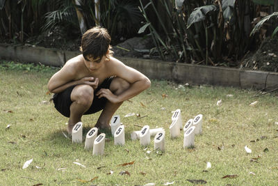 Low section of woman sitting on field