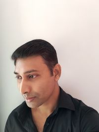 Portrait of smiling young man against white background