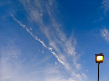 Low angle view of illuminated street light against sky