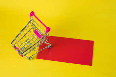 High angle view of traditional equipment on table against yellow background