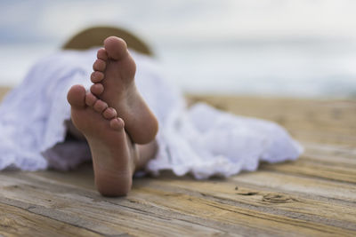 Low section of child lying on floor