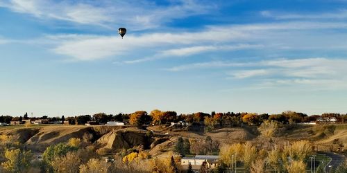 Hot air balloon over a coulee in bluesky