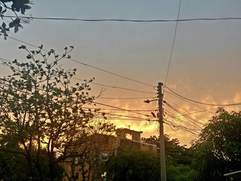 Low angle view of power lines against sky