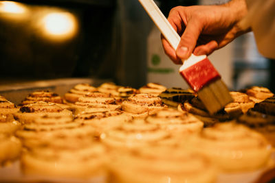 Cropped hand of person preparing food