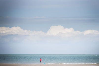 Scenic view of sea and man against sky