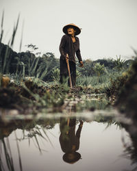 Side view of woman standing in lake