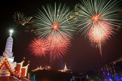 Low angle view of firework display at night