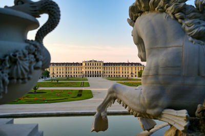 Statue of city against sky during sunset