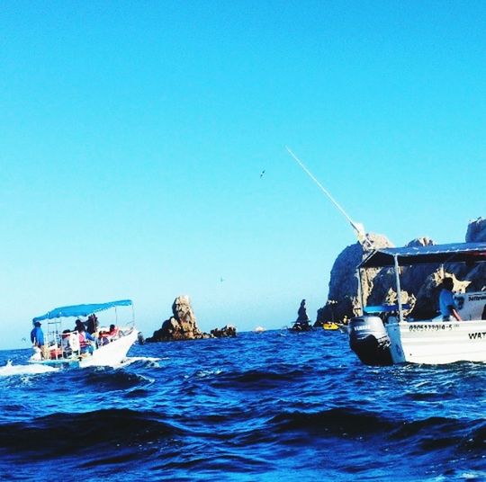 water, nautical vessel, transportation, clear sky, mode of transport, sea, boat, waterfront, copy space, blue, sailing, horizon over water, men, travel, nature, day, leisure activity, scenics, vacations