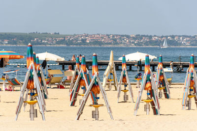 People at beach against sky