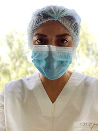 Close-up portrait of female surgeon wearing surgical mask outdoors