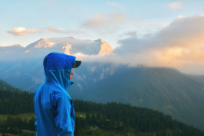 Rear view of man against mountain range