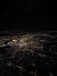 Aerial view of illuminated city against sky at night