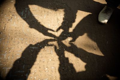 Shadow of man on road