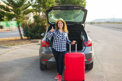 Portrait of young woman on road