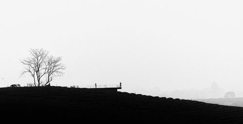 Silhouette building against clear sky