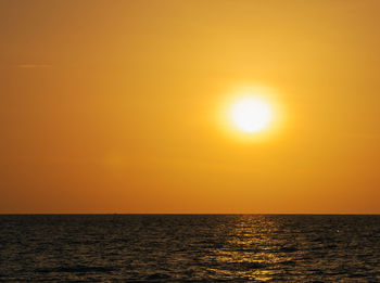Scenic view of sea against orange sky
