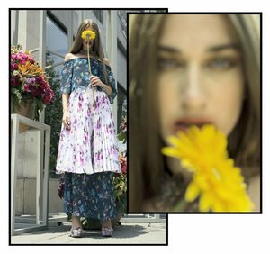 Woman standing by yellow flowering plants