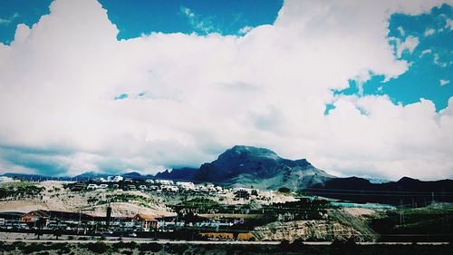 Buildings against cloudy sky