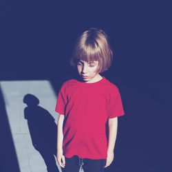 Boy standing against blue background