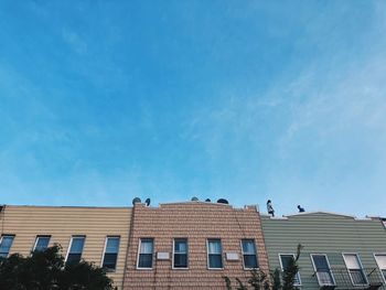 Low angle view of building against blue sky