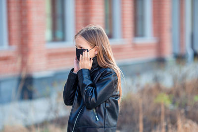 Young woman photographing with camera