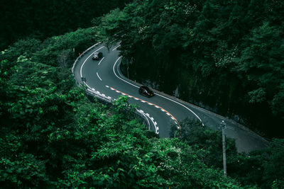 High angle view of cars moving on winding road