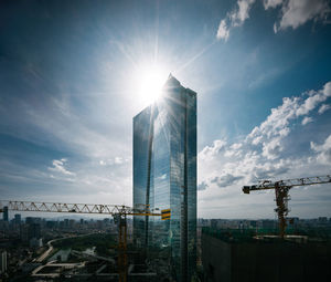 Modern buildings against sky on sunny day