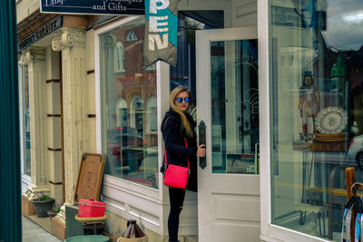 Woman standing by window at store