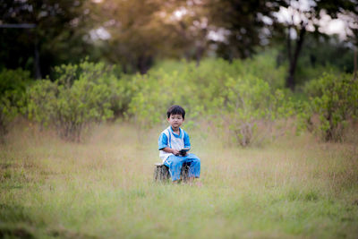 Portrait of boy on grassy field