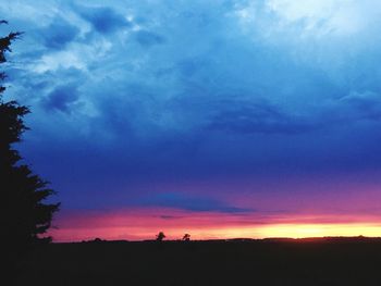 Silhouette of landscape against cloudy sky