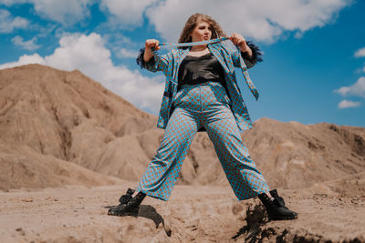 Low angle view of woman standing on sand