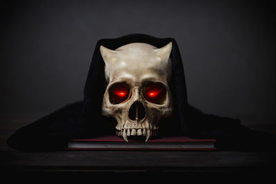 Close-up of human skull against black background