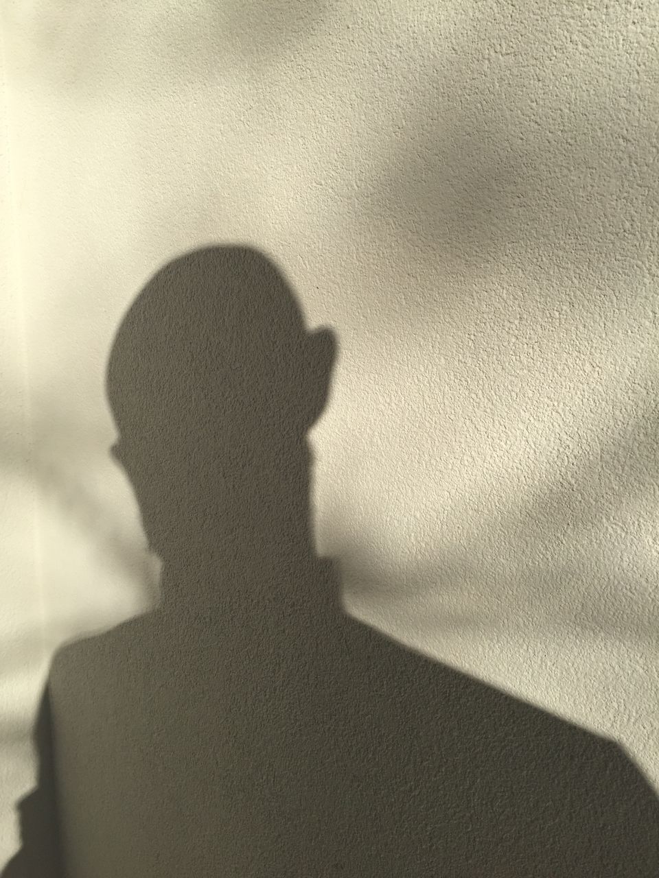 SHADOW OF WOMAN ON WALL