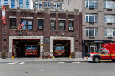 Cars on road by buildings in city