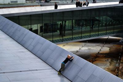 High angle view of man walking on footbridge