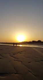 Scenic view of beach against sky during sunset