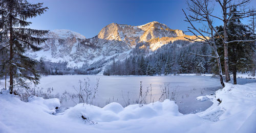 Scenic view of snow covered mountains against sky