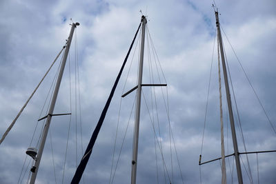 Low angle view of sailboat mast against sky