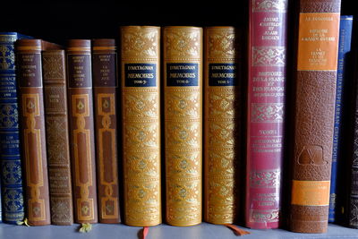 Close-up of old books arranged in shelf at library