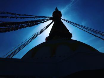 Low angle view of cross against cloudy sky