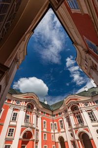 Low angle view of building against cloudy sky