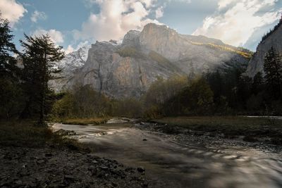 Scenic view of lake by mountains against sky