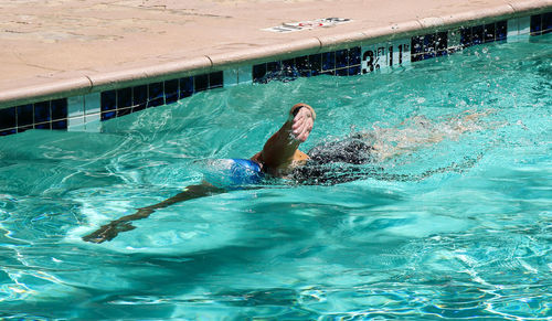 Side view of woman swimming in pool