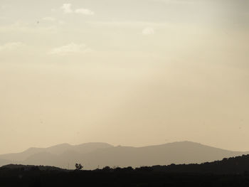 Scenic view of silhouette landscape against sky during sunset