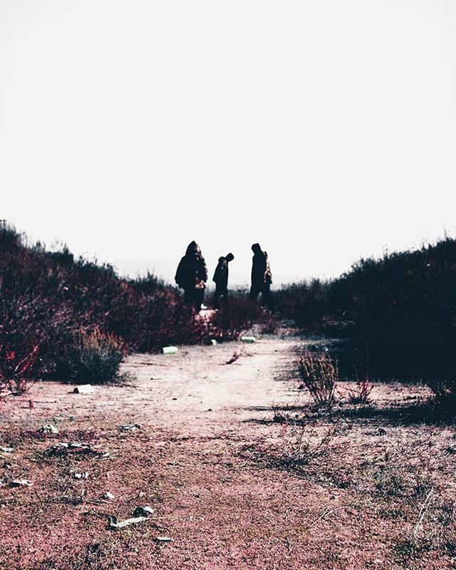 clear sky, copy space, lifestyles, men, rear view, the way forward, leisure activity, walking, full length, tranquility, tranquil scene, landscape, person, nature, dirt road, field, outdoors