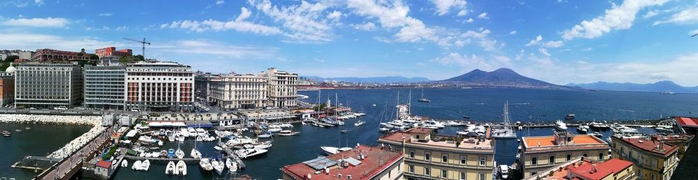 High angle view of city by sea against sky