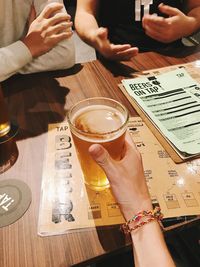 High angle view of man holding coffee cup on table